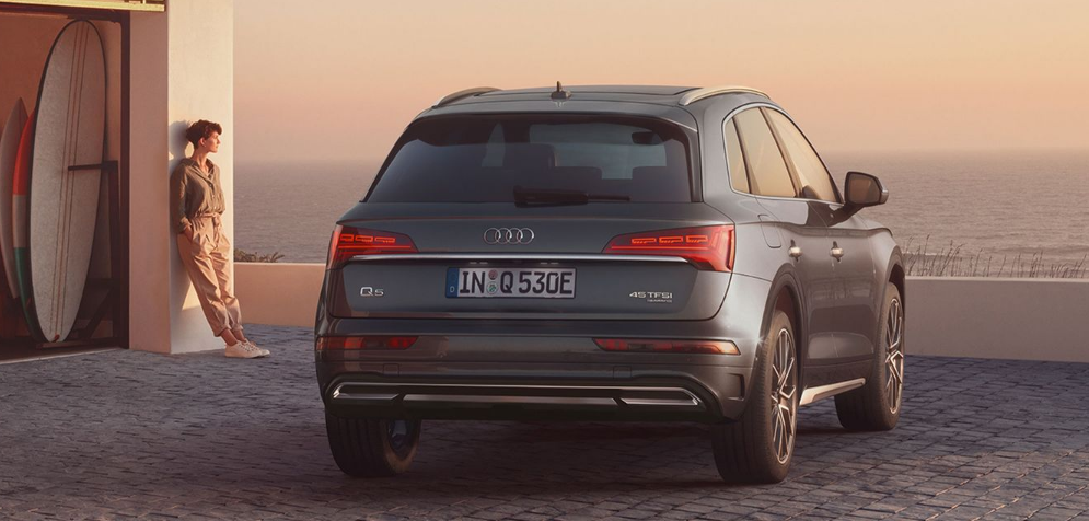 2024 Audi Q5 parked on a paved driveway near a coastal location at sunset-Features