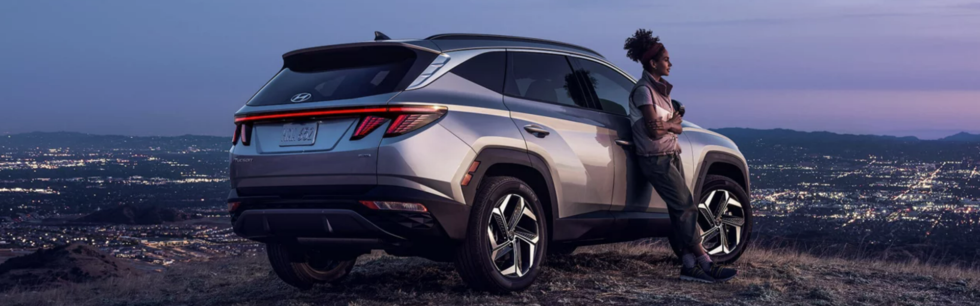 2024 Hyundai Tucson parked on a hill overlooking a cityscape Banner