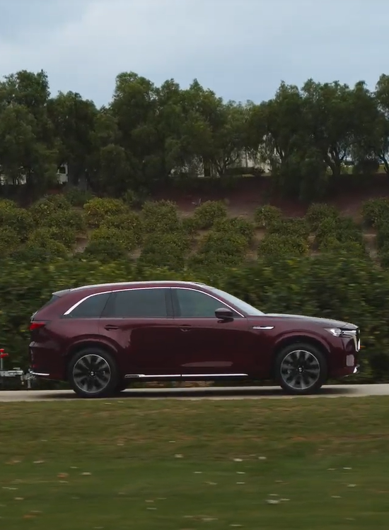 2024 Mazda CX-90 running with side view