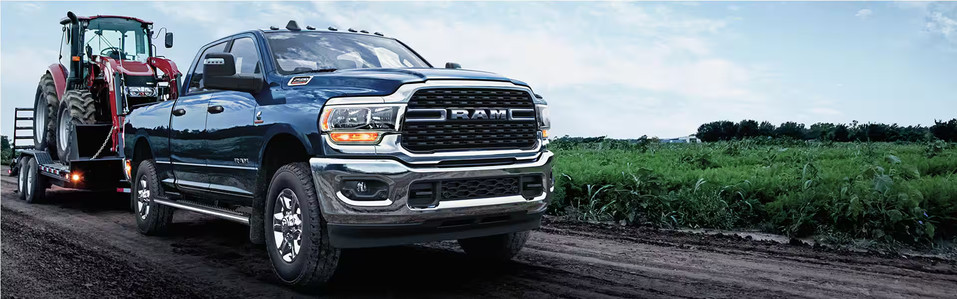 2024 Ram 2500 towing a large piece of farming equipment-Banner