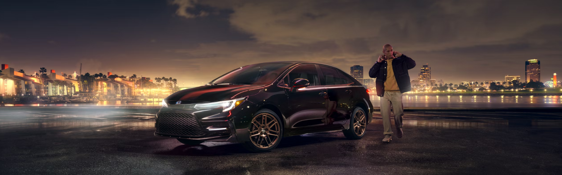 2024 Toyota Corolla Hybrid parked against an urban nighttime backdrop-Banner