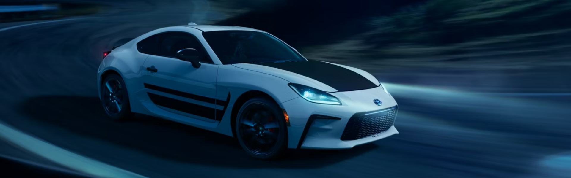 2024 Toyota GR86 with speeding through a nighttime or low-light setting-Banner
