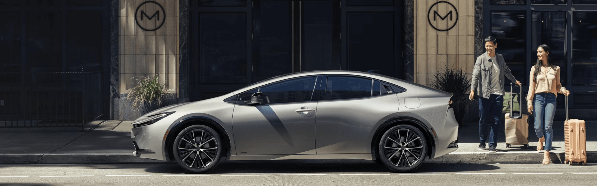 2024 Toyota Prius parking couple getting to the vehicle