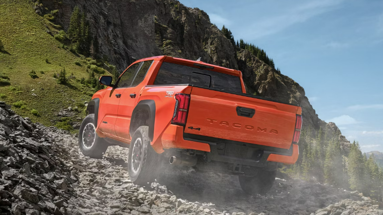 2024 Toyota Tacoma Double Cab in orange with rear view