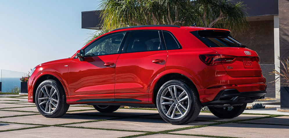 2025 Audi Q3 parked near a modern home with palm trees in the background-Features