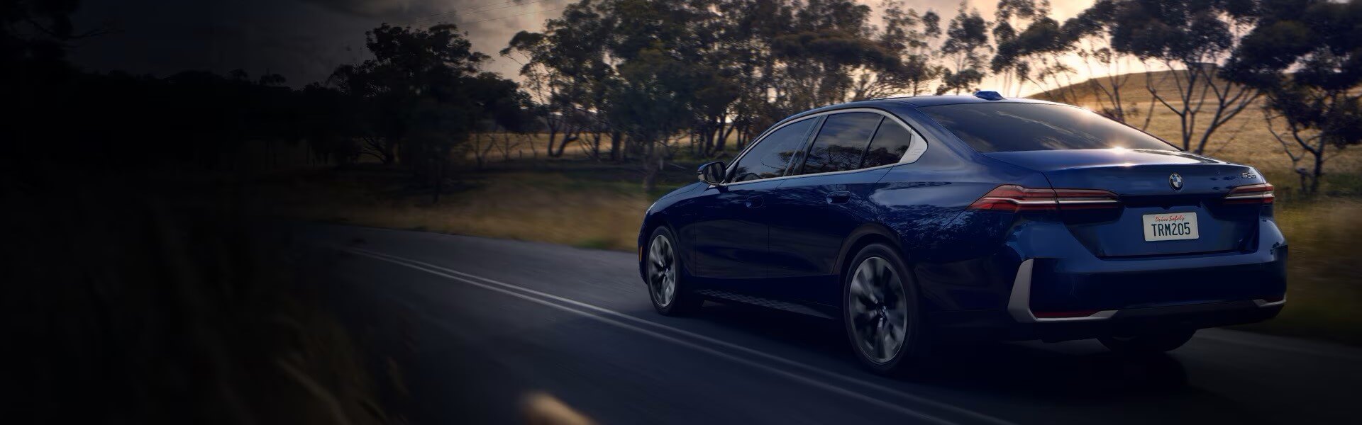 2025 BMW 5 Series Sedan Driving Down The Road For Sale