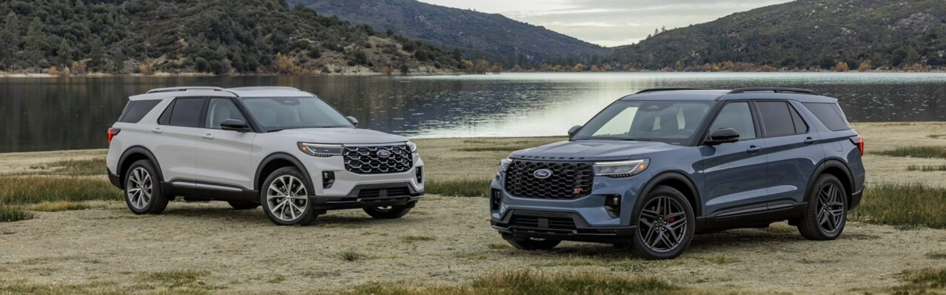 2025 Ford Explorer parked near a scenic lake with mountains in the background Banner
