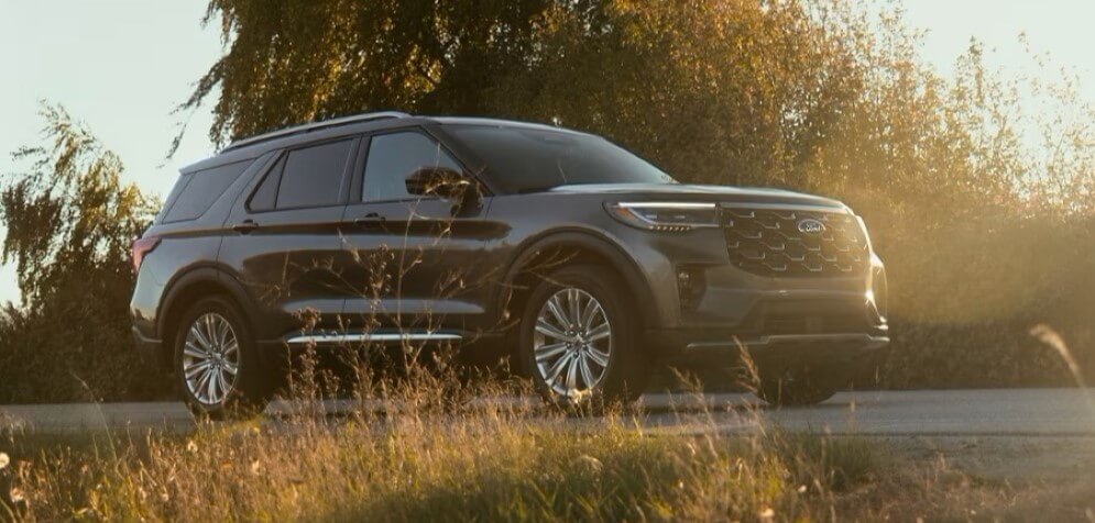 2025 Ford Explorer Platinum Driving Down A Rural Road - Feature Image