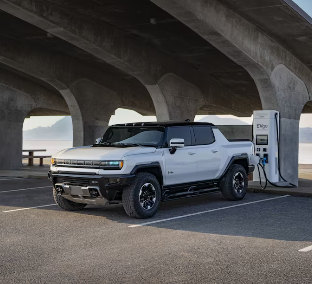 2025 GMC Hummer EV Pickup at an electric vehicle (EV) charging station