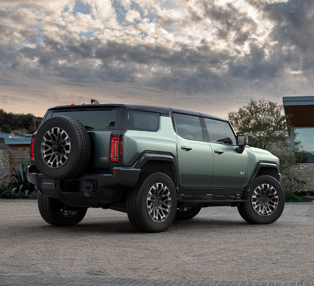 2025 GMC Hummer EV SUV with a backdrop of a cloudy sky