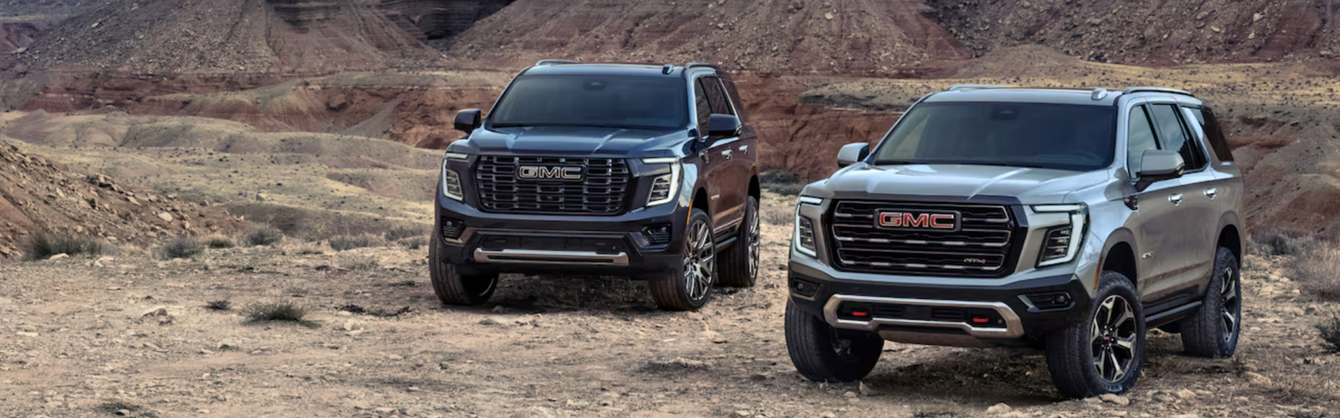 2025 GMC Yukon parked in a rugged, desert-like landscape-Banner