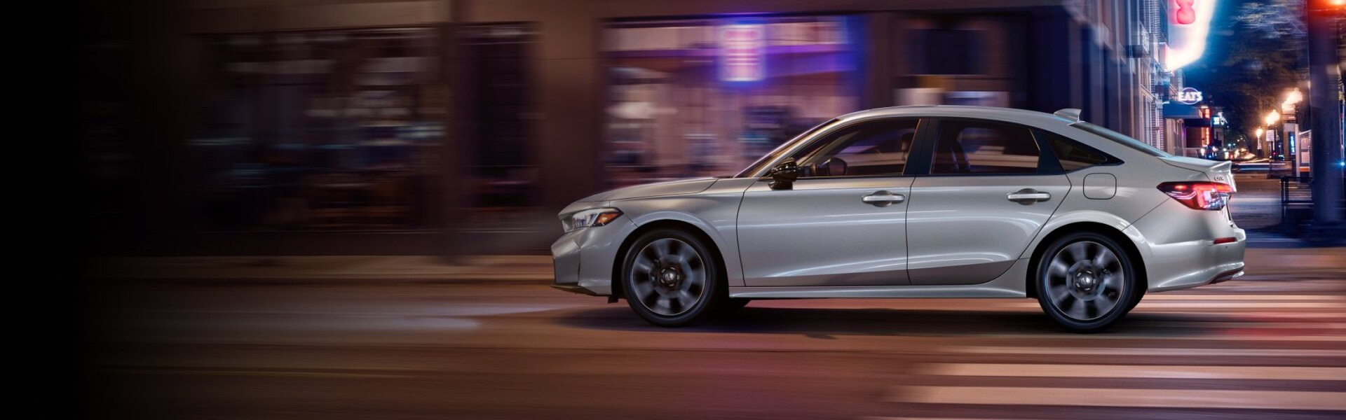 2025 Honda Civic cruising down the street, captured in a side view-Banner