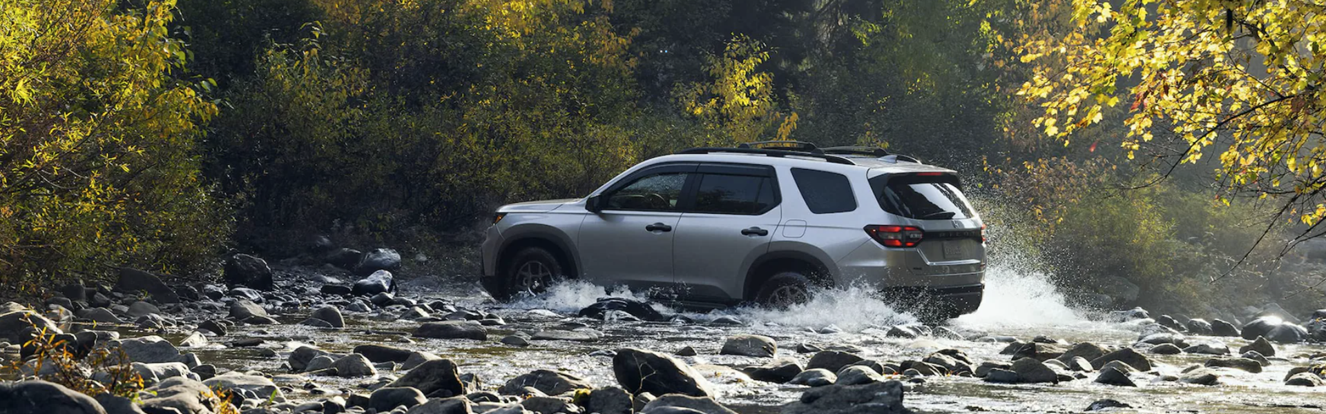 2025 Honda Pilot in grey driving through a stream with side view FOR SALE