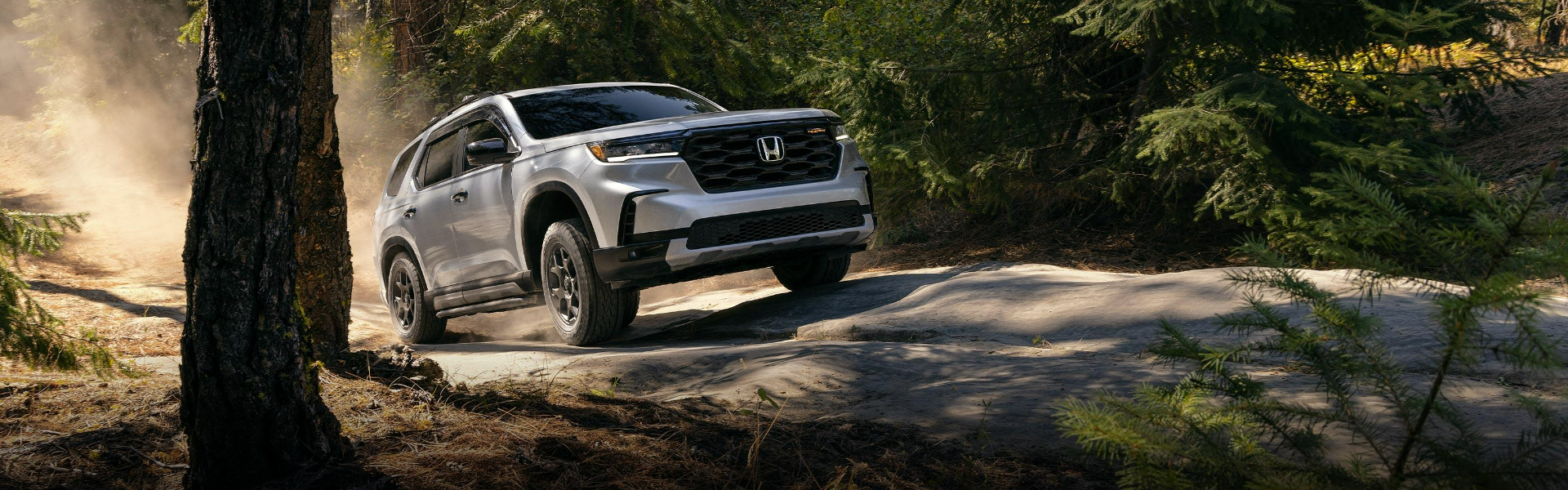 2025 Honda Pilot running with front view banner