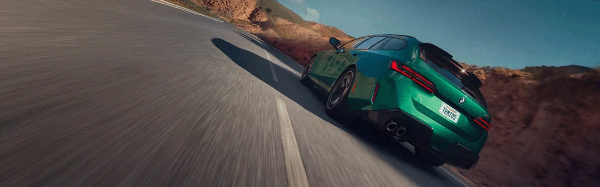 2025 M5 Touring driving through a rocky countryside - Banner