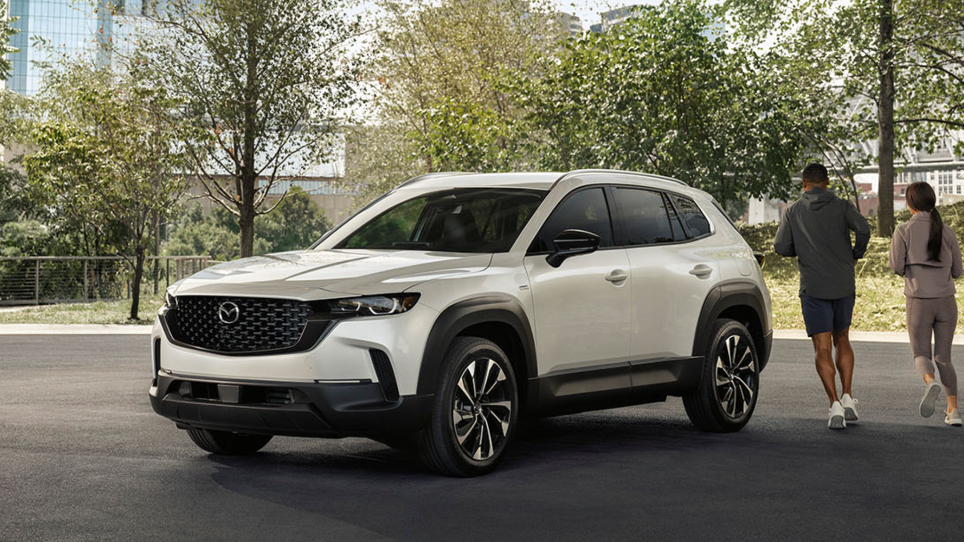 2025 Mazda CX-50 Hybrid in white parked with front and side view-features