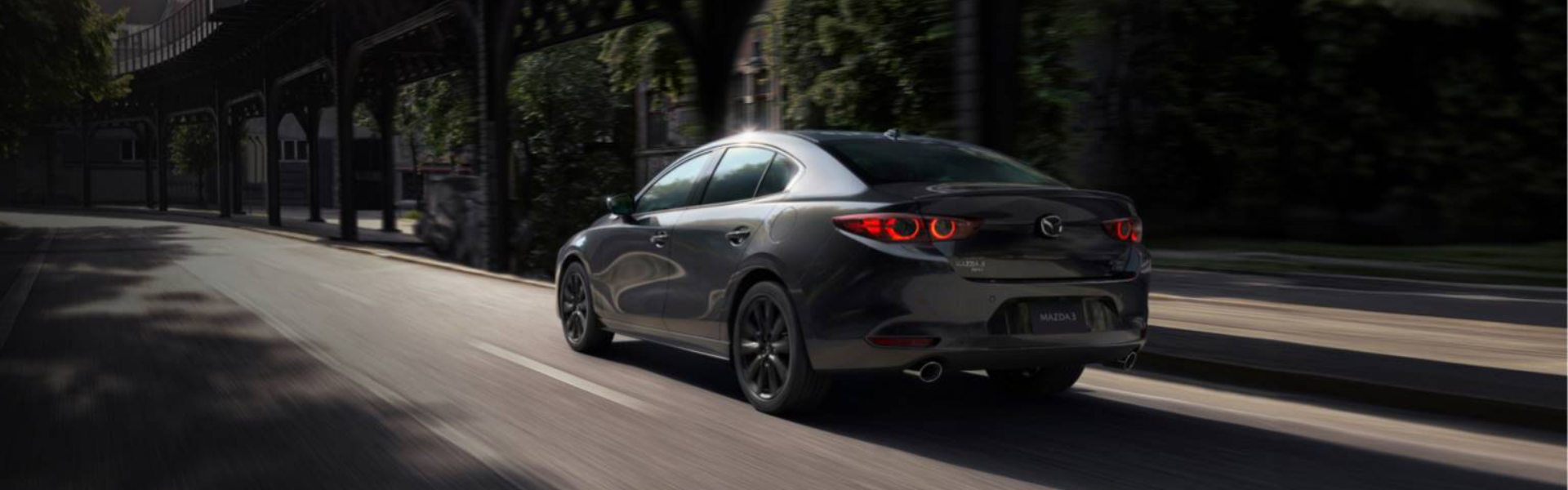 2025 Mazda3 Sedan running on street with rear view-Banner