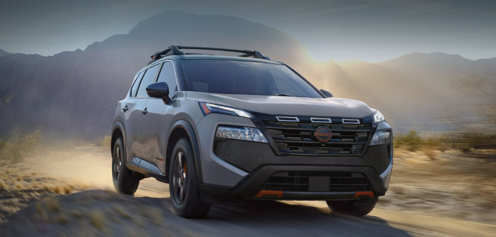 2025 Nissan Rogue driving through a dusty and rugged off-road terrain-Features