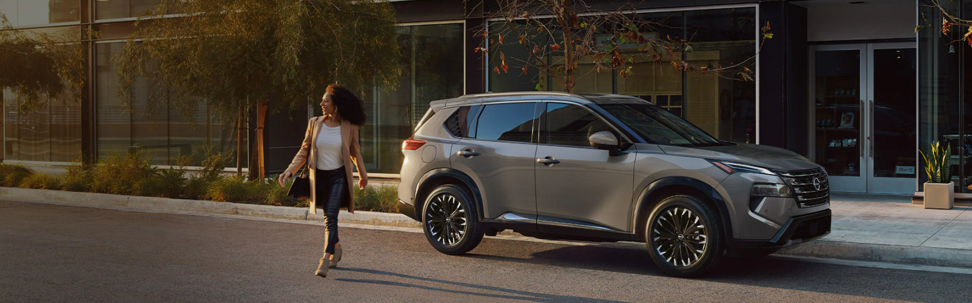 2025 Nissan Rogue parked outside an upscale urban building-Banner