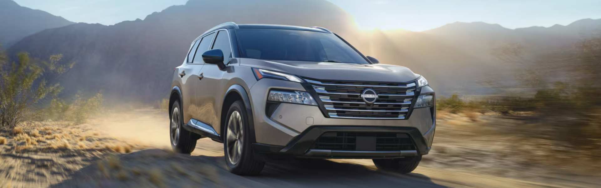 2025 Nissan Rogue Rock Creek driving through a desert or rugged terrain-Banner