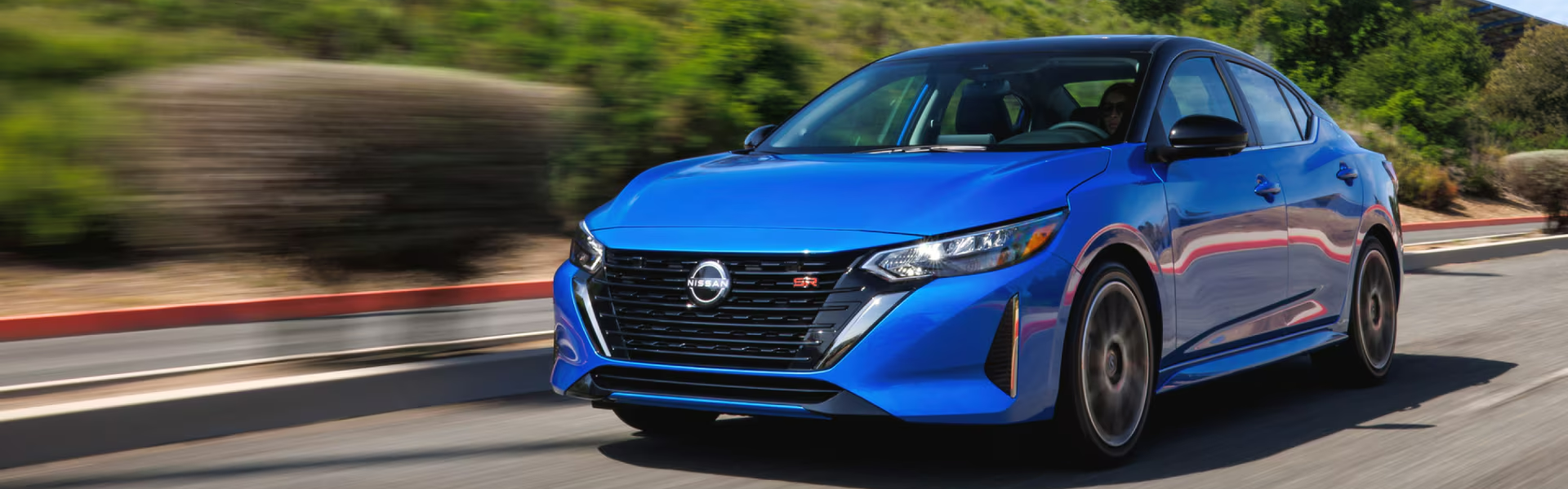 2025 Nissan Sentra in blue running with front view-Banner
