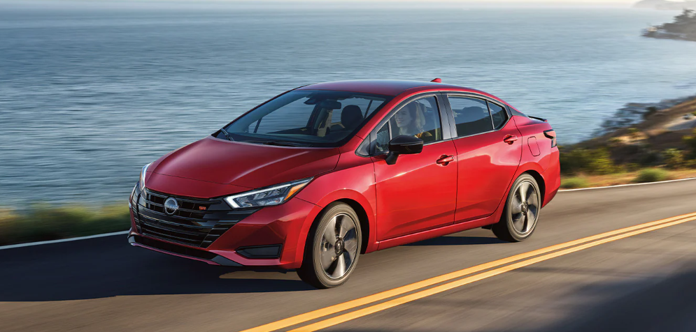 2025 Nissan Versa is red running with side view-Features