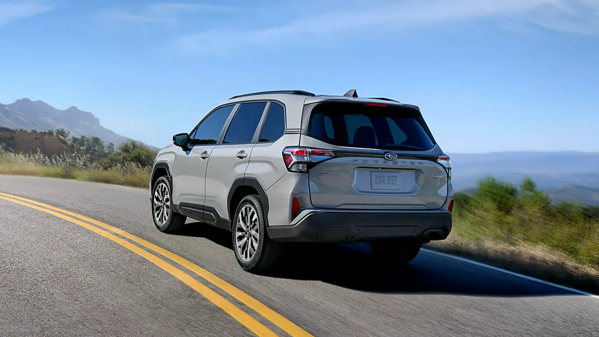 2025 Subaru Forester driving along a scenic road