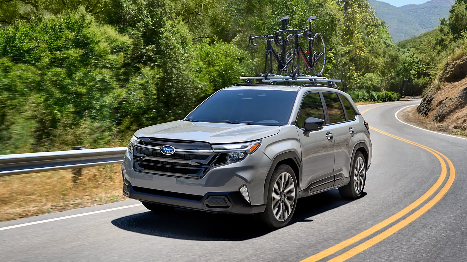 2025 Subaru Forester driving along a winding road