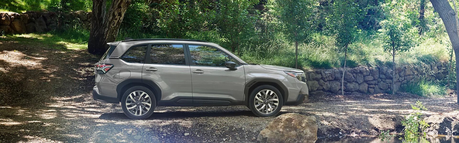 2025 Subaru Forester Parked In A Forest Banner