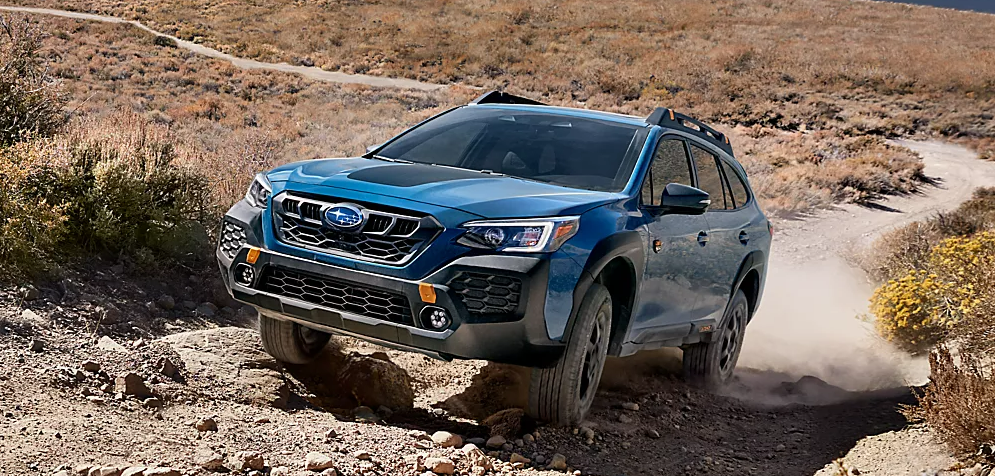 2025 Subaru Outback climbing up a rocky hill