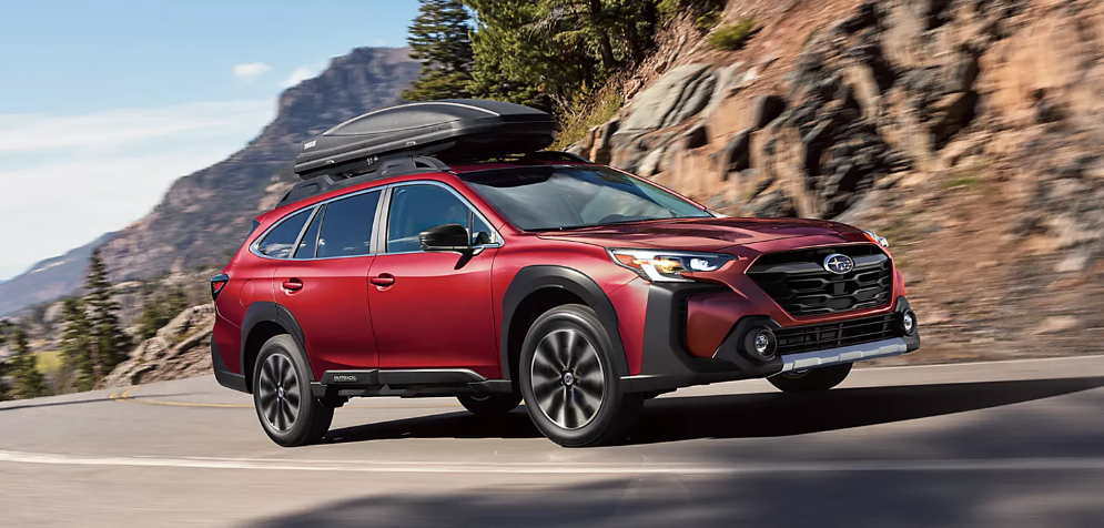 2025 Subaru Outback driving on a winding mountain road