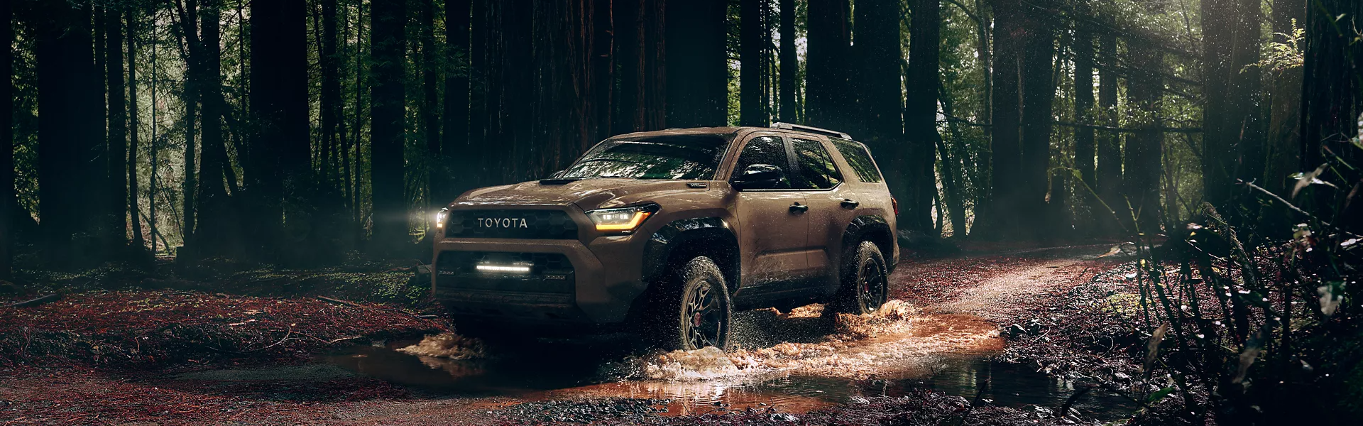 2025 Toyota 4Runner driving through a muddy, forested area-For Sale