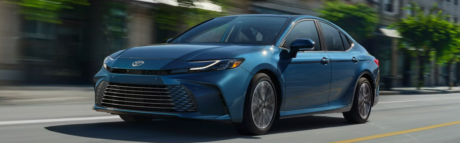 2025 Toyota Camry in blue running with front view and side view BANNER
