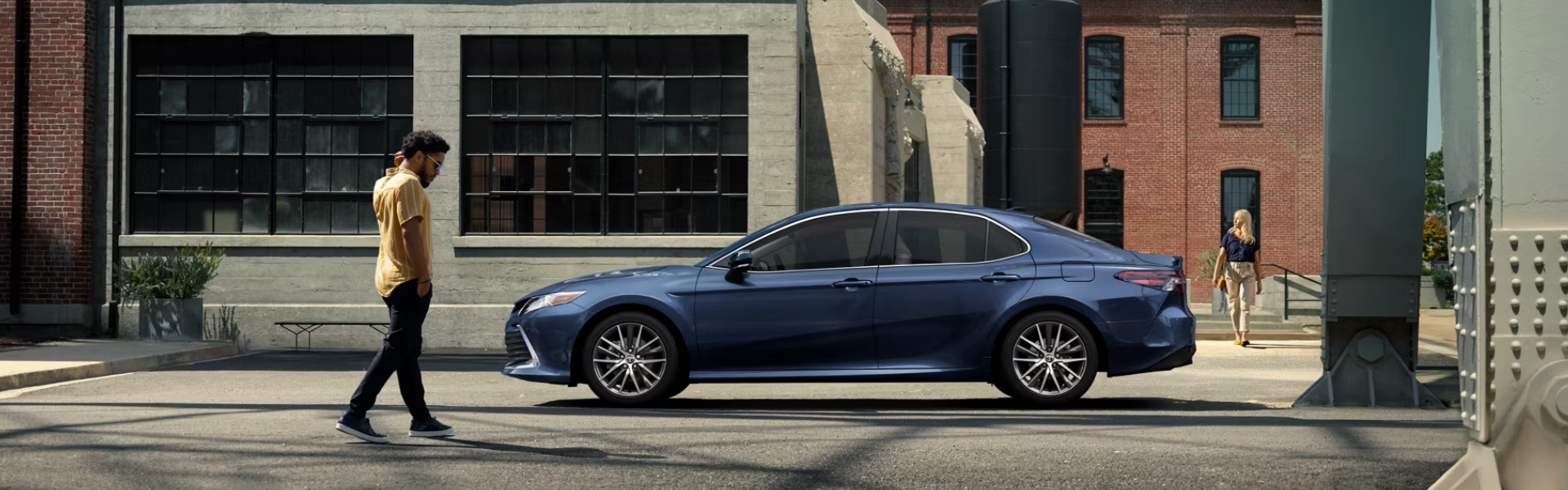 2025 Toyota Camry parked on a street with industrial buildings in the background FOR SALE