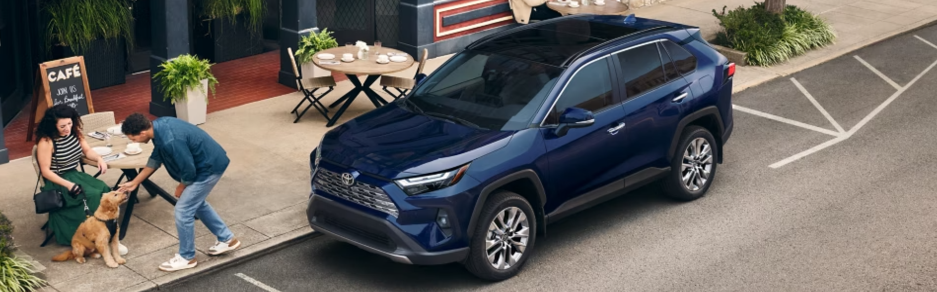 2025 Toyota RAV4 parked next to a sidewalk cafe-Banner