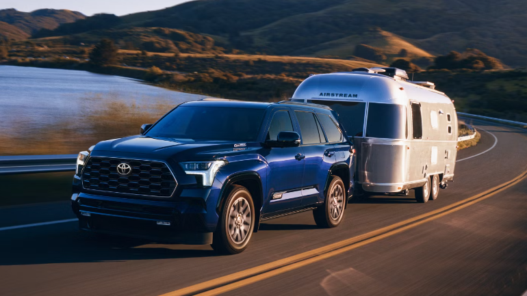 2025 Toyota Sequoia towing a silver Airstream trailer along a scenic-Features