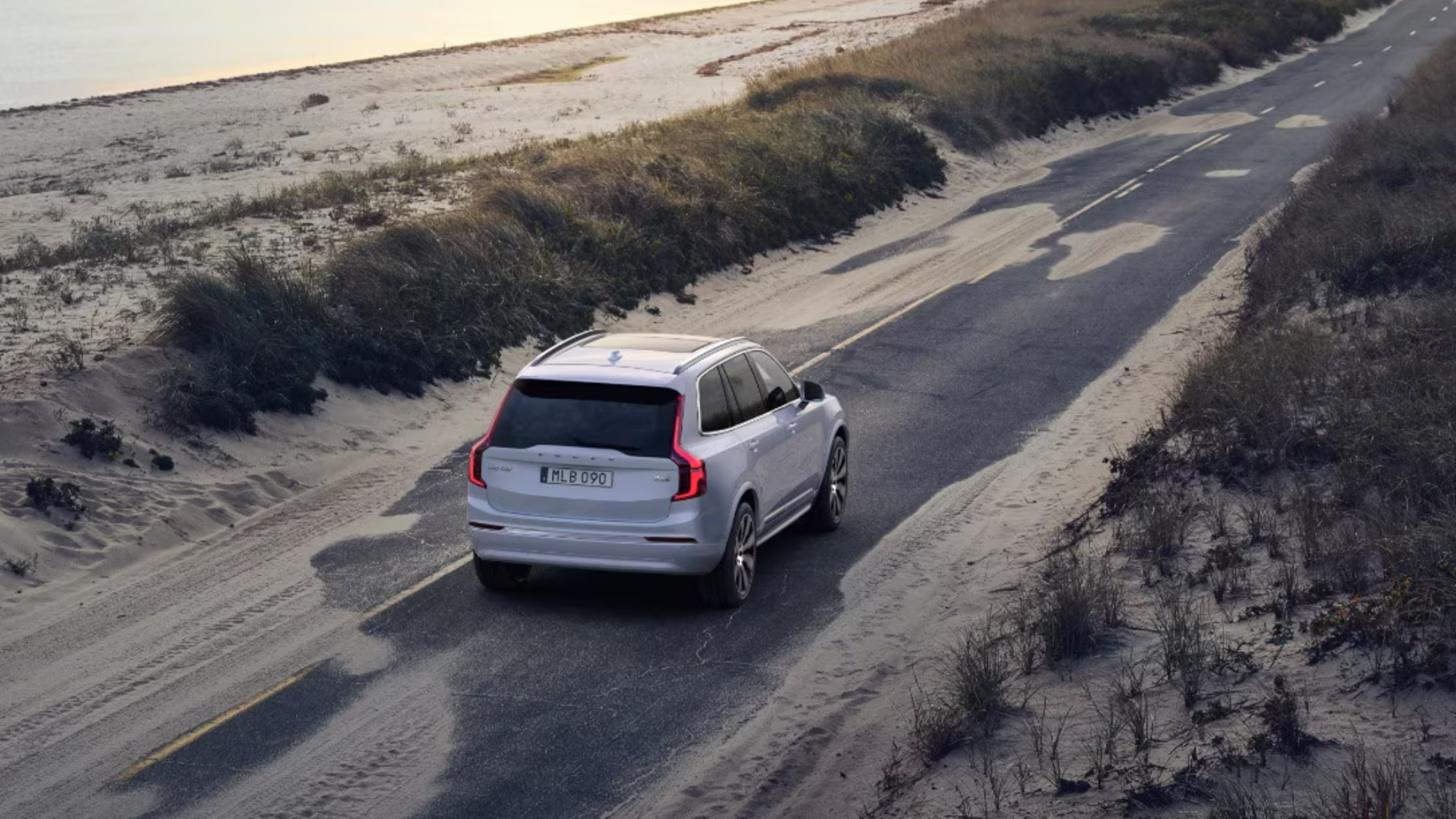 2025 Volvo XC90 driving on a narrow road through a sandy and coastal area-Features