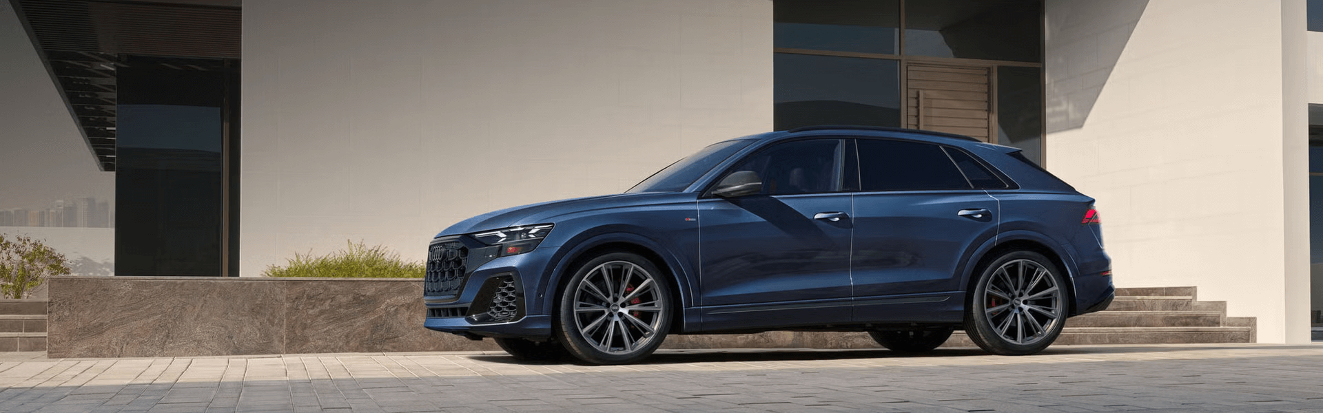 2026 Audi Q8 Parked in Front of Modern Home Banner