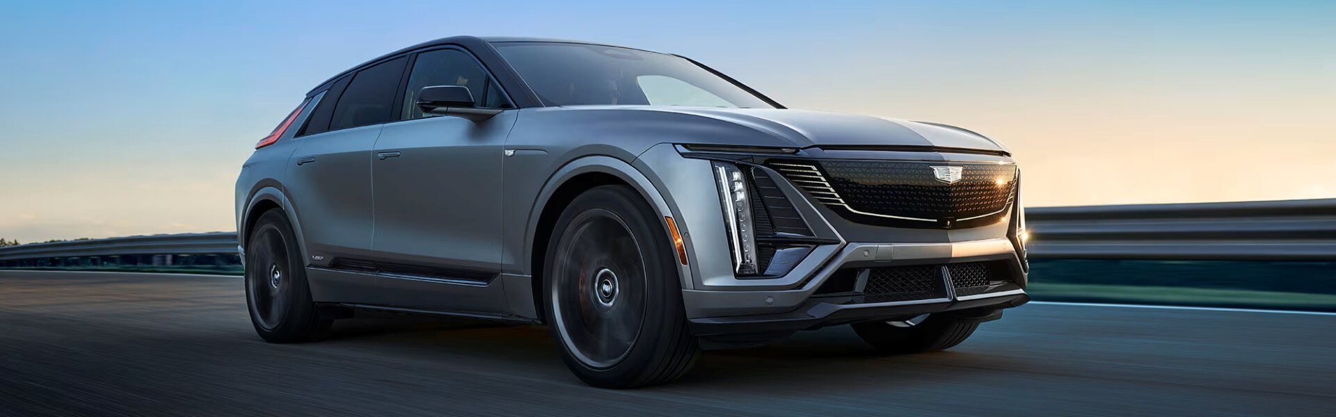 2026 Cadillac LYRIQ-V Driving Down A Road Banner