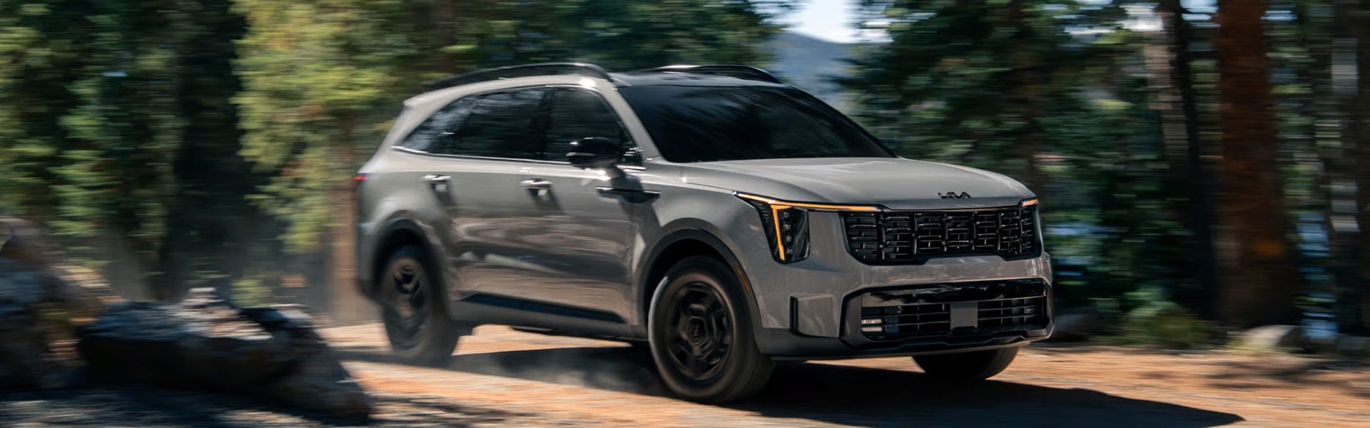 2026 Kia Sorento driving off road in the forest Banner