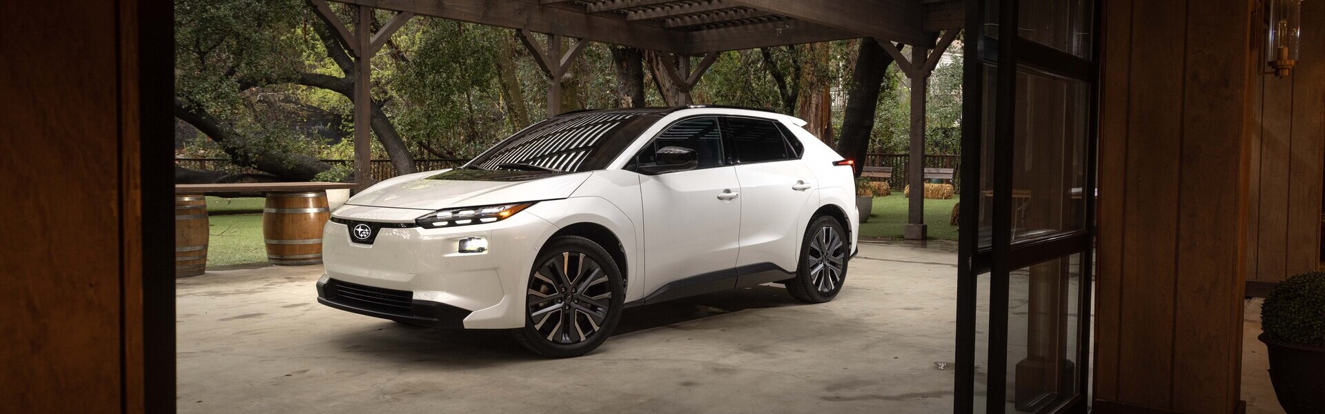 2026 Subaru Solterra Next to Rustic Building Banner