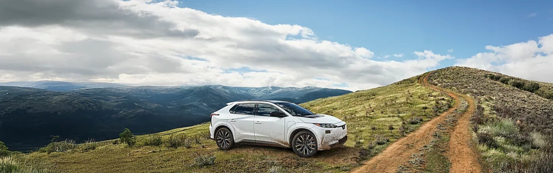 2026 Subaru Solterra parked on a remote mountain road Banner