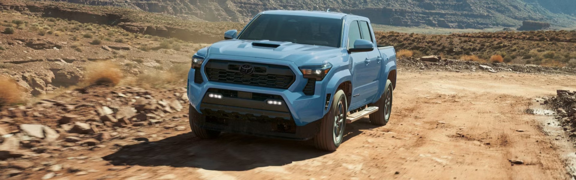 2026 Toyota Tacoma TRD Sport Shown In Heritage Blue With Available Side Step Accessory Banner