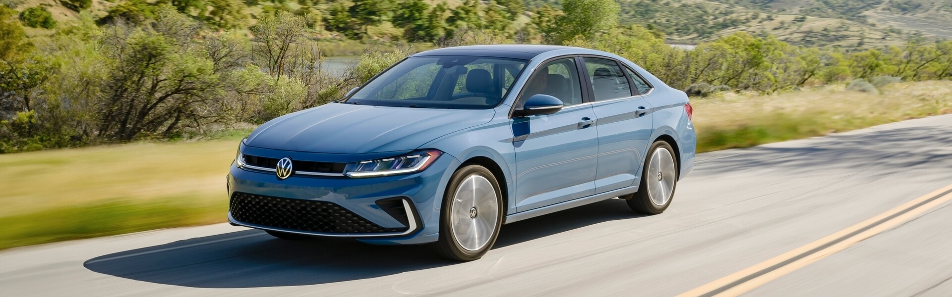 2026 Volkswagen Jetta Driving Through Rolling Hills Banner