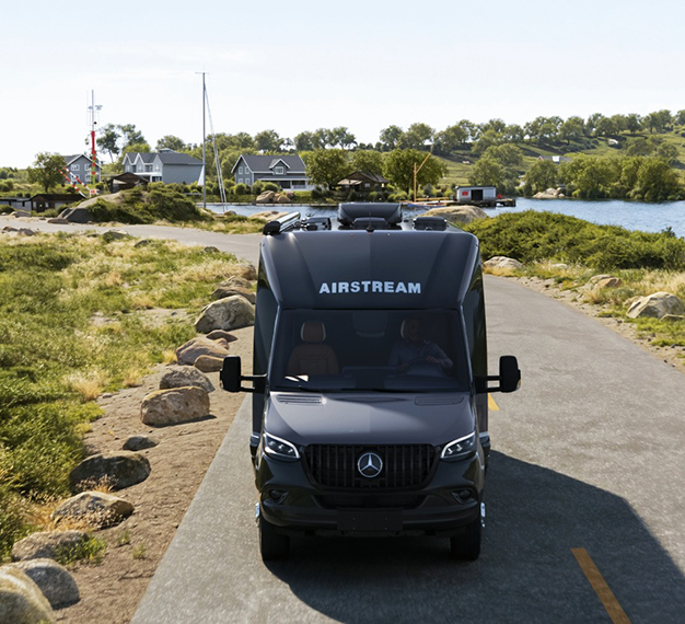 Airstream seen from above traveling along a coastline