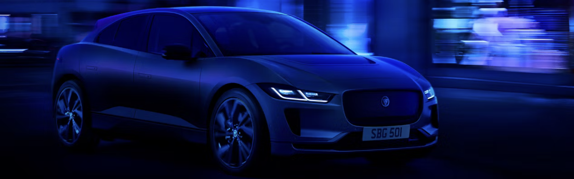 Jaguar I-PACE running on street banner