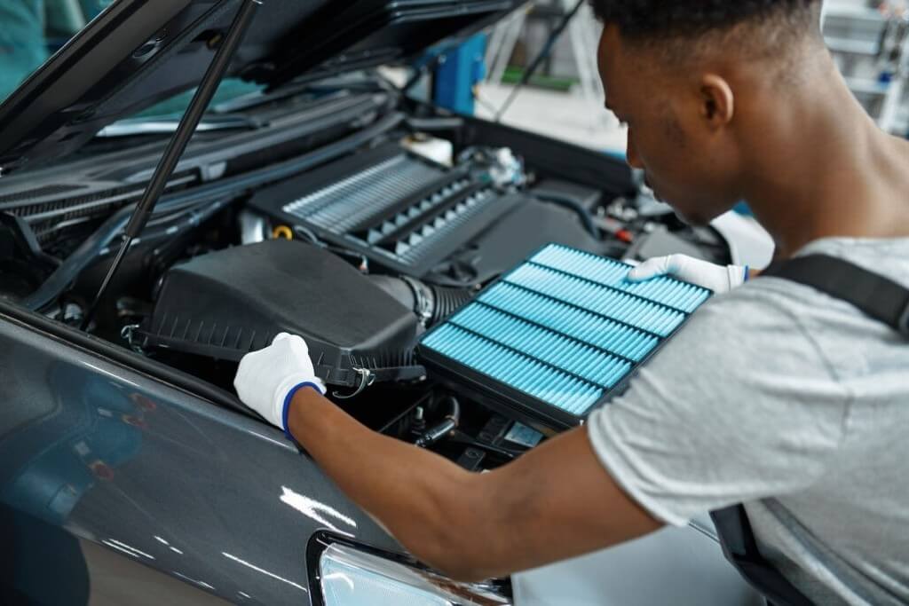 Male Mechanic Changes Air Filter Car Service - Feature Image
