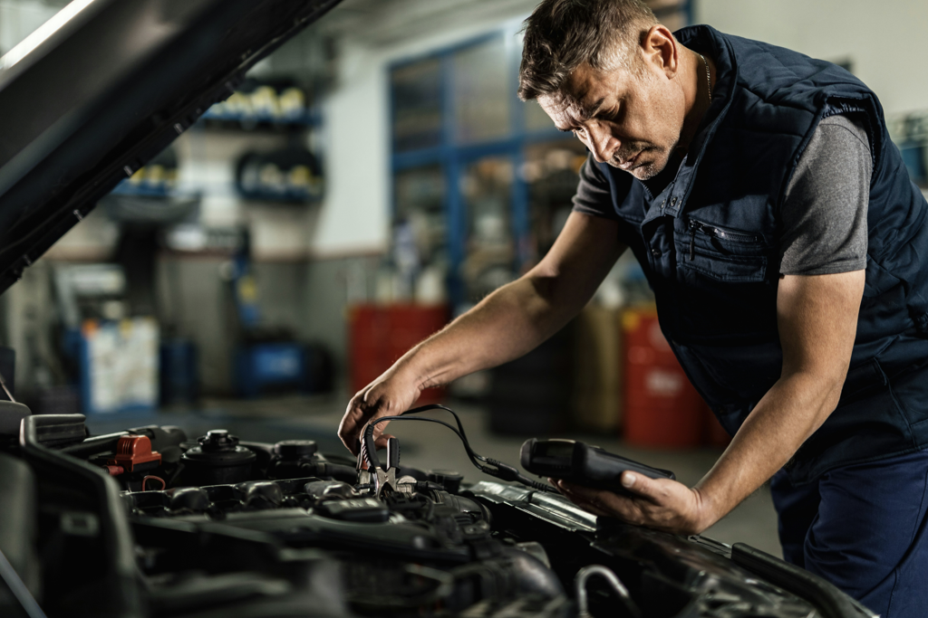 Man checking vehicle's battery