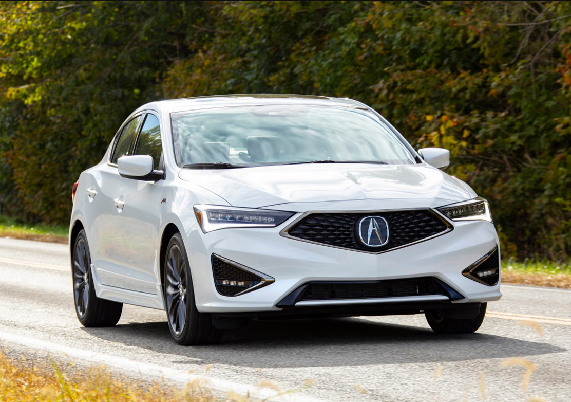 Quality Pre-Owned Acura ILX Driving On A Road Surrounded By Greenery