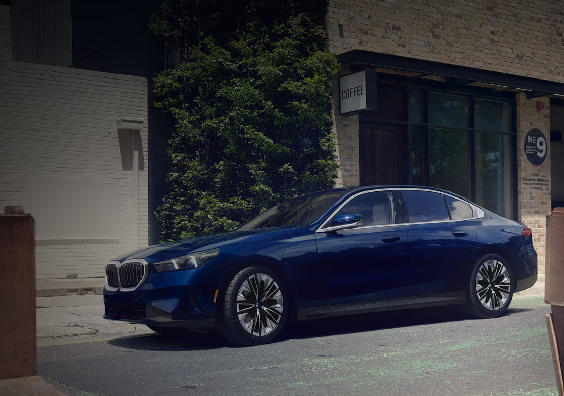 Quality Pre-Owned BMW 5 Series Parked Outside A Coffee Shop - Feature Image